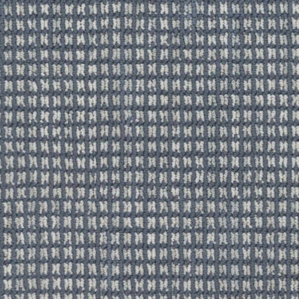 Close-up of Haven Berber Carpet in Nautical, showcasing a textured fabric with a small, repeating blue and white checkered pattern, echoing the durable and intricate grid-like design characteristic of Berber carpets.
