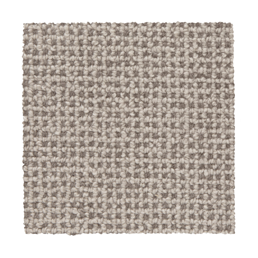 The Needlepoint III Berber Carpet swatch in Quartz features a tightly woven, looped pattern in light beige and gray. Ideal for high-traffic areas, the square sample is shown against a white background.