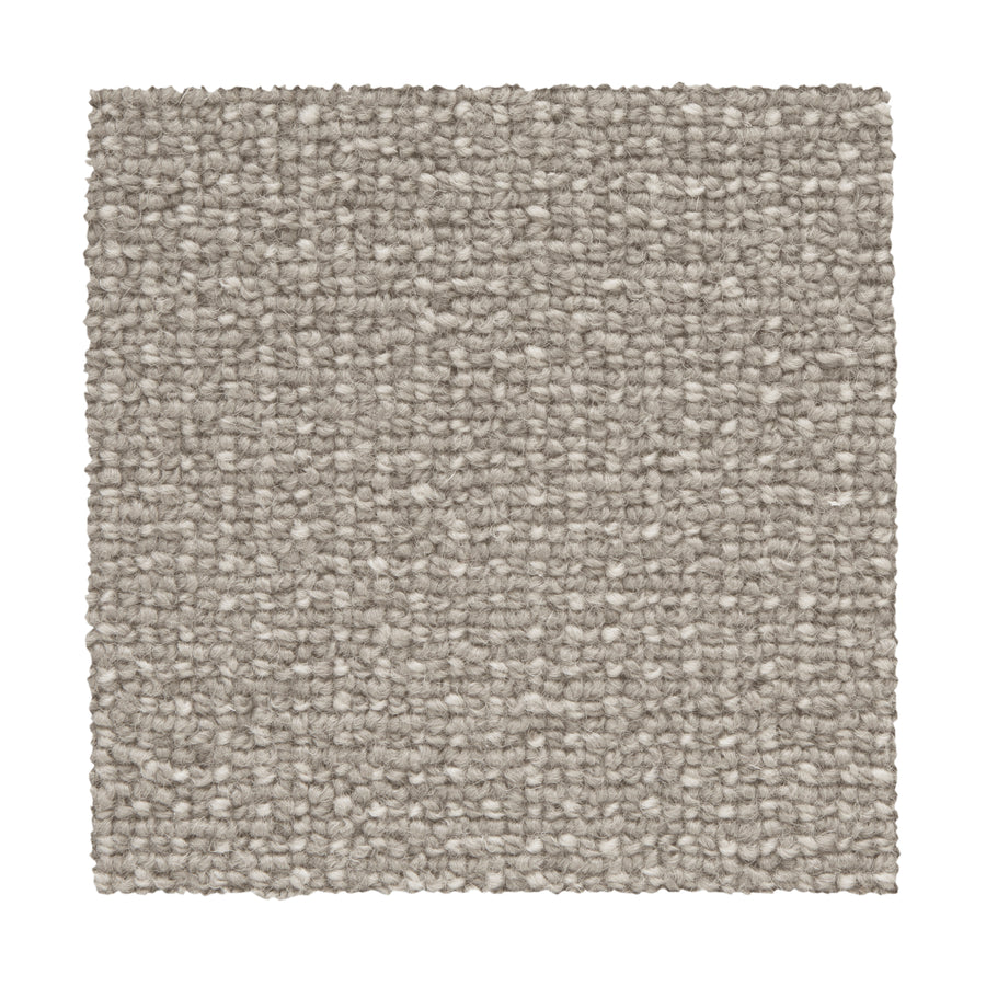 A square sample of Needlepoint III Berber Carpet in Mortar is shown on a white background, highlighting its light gray color and uniform, tightly woven texture ideal for high-traffic areas.