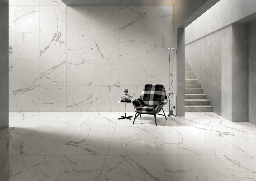 Modern minimalist room with Donatello 24x48 3D Rectified Porcelain Tile flooring, a checkered armchair, small side table with stacked books, floor lamp, and concrete stairs ascending on the right.