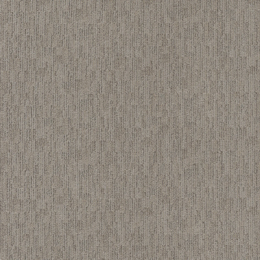 Close-up of Sneak Peak Berber Carpet in Nightingale color, featuring a textured, dense pile with a subtle linear pattern in brown and gray tones. Its soft, durable surface provides lasting comfort and style, resembling classic woven fabric.