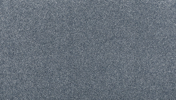 A close-up of Noble Surface Pet Friendly Carpet in Day Dream shows a blue-gray textured surface with tiny, irregular speckles—offering a stain resistant, stylish, and practical flooring solution.