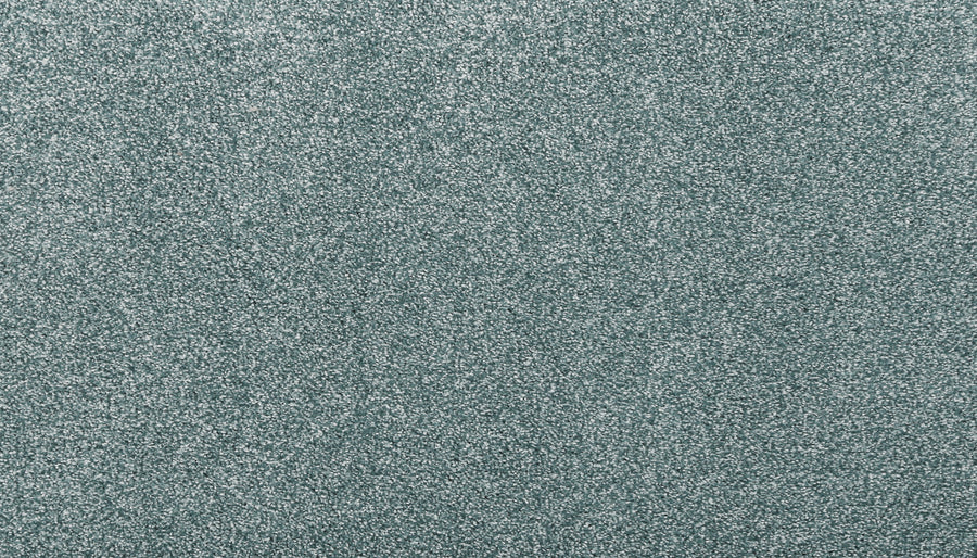 Close-up of Noble Surface Pet Friendly Carpet in Sea Mist, featuring a light blue-gray, textured, stain-resistant finish with a fine, glittery appearance—ideal for homes with pets.