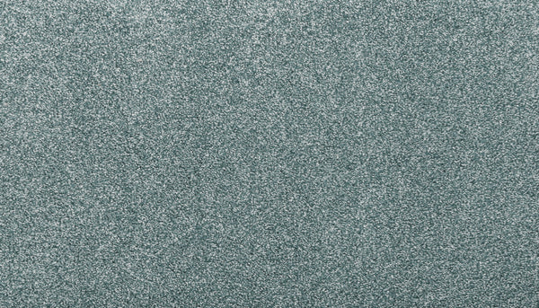 Close-up of Noble Surface Pet Friendly Carpet in Sea Mist, featuring a light blue-gray, textured, stain-resistant finish with a fine, glittery appearance—ideal for homes with pets.
