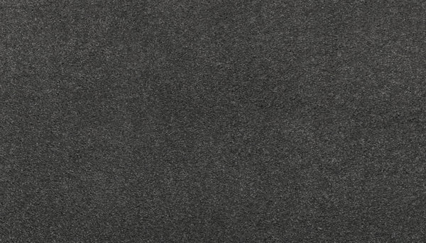A close-up of the Noble Surface Pet Friendly Carpet in Shadow color reveals its consistent, slightly rough texture and dark gray pattern, highlighting its durability and pet-friendly design.