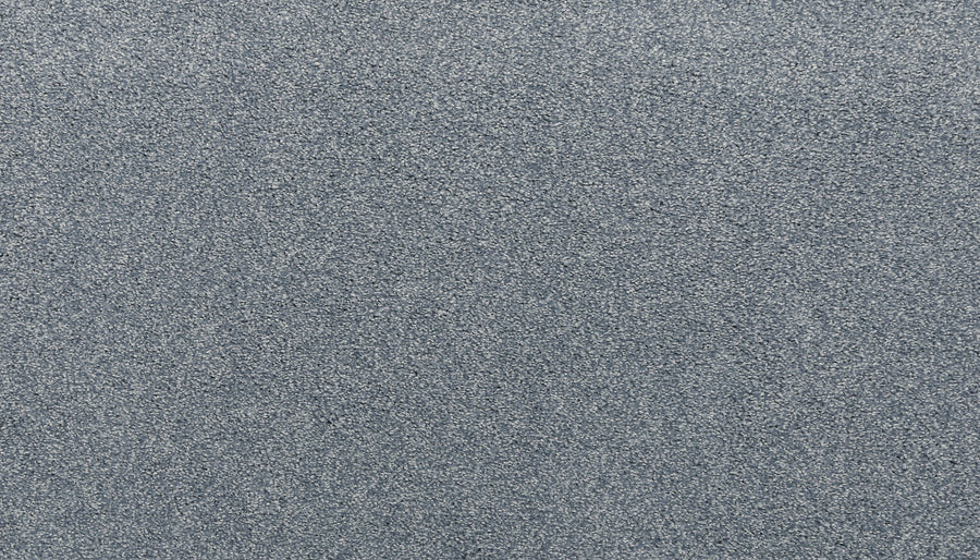 A close-up view of Noble Tone Pet Friendly Carpet in Hydrangea, featuring a textured gray surface with a subtle shimmer and durable, grainy pattern—ideal for resilient flooring in pet-friendly homes.