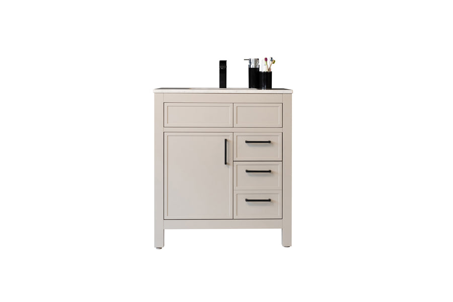 A beige bathroom vanity with a black faucet, three drawers, one cabinet door, and toiletries arranged on the countertop.