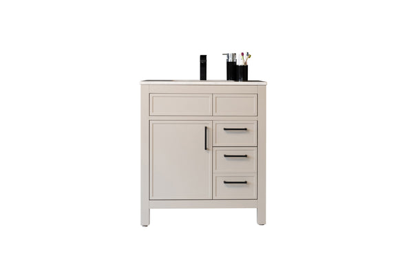 A beige bathroom vanity with a black faucet, three drawers, one cabinet door, and toiletries arranged on the countertop.