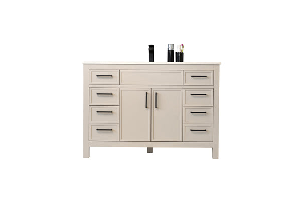 A beige dresser with six drawers, two central cabinet doors, and black handles. Three items, including a black bottle and two glass containers, are arranged on top. The background is plain white.