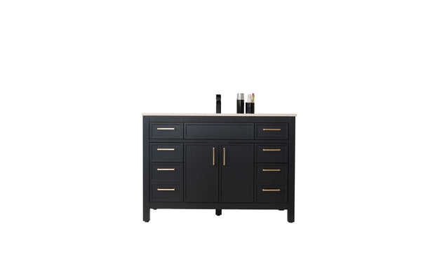 A modern black bathroom vanity with gold handles, a white countertop, double center doors, eight drawers, and a black faucet. Toiletries and a cup are placed on the right side of the countertop.