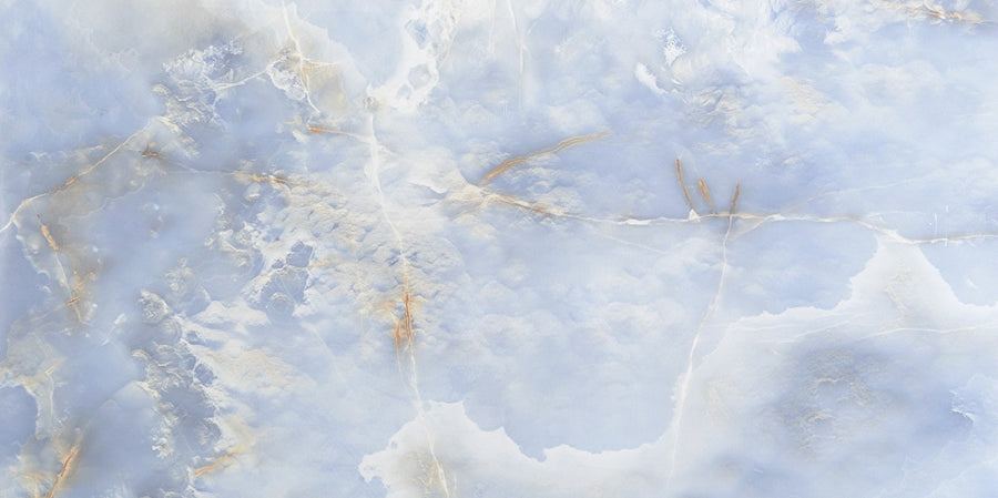 The Exuma 24x48 Polished Glazed Porcelain Tile showcases light blue and white marbling with subtle beige veins, offering an elegant, sophisticated appearance.