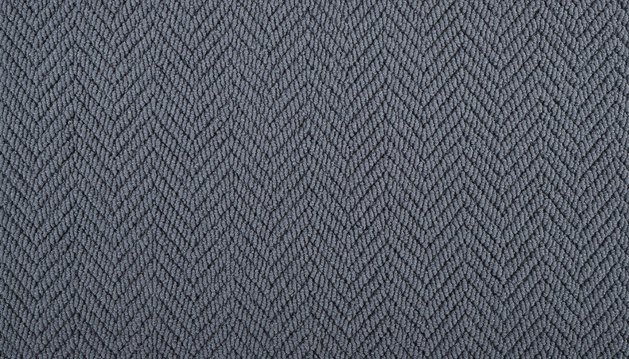 Close-up of the Bespoke On Trend Carpet shows its textured gray fabric and subtle herringbone pattern, featuring diagonal zigzag (chevron) lines for a luxurious look.