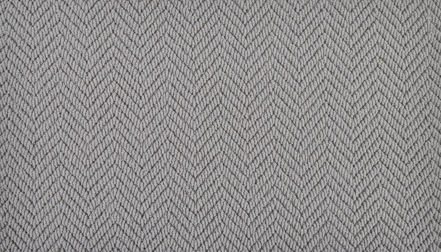 Close-up of Bespoke On Trend Carpet in light gray, showcasing a subtle herringbone pattern with diagonal zigzag lines for a textured, woven look.