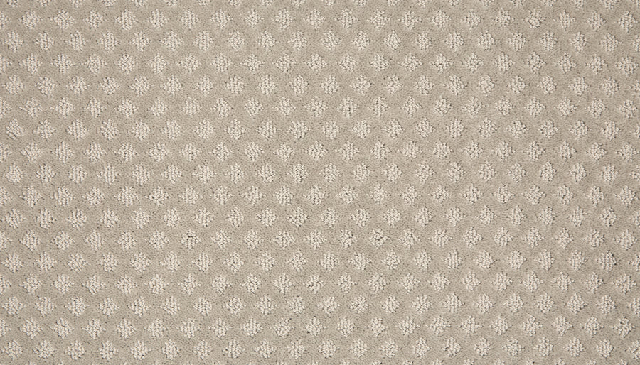 A close-up of Retro Revival Pet Friendly Carpet shows a beige textured fabric with small, raised ovals in an even pattern. This soft, woven luxury carpet is ideal for adding elegance and durability to any space.