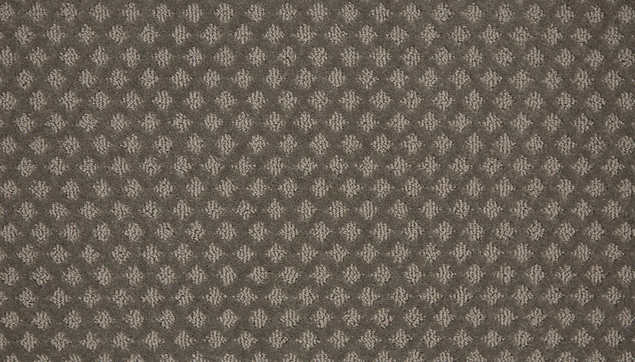 Close-up of Retro Revival Pet Friendly Carpet in brown, featuring a textured surface with evenly spaced small light beige diamond-shaped patterns.