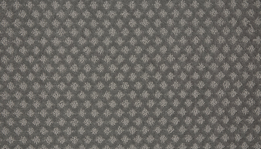 Close-up of Retro Revival Pet Friendly Carpet in gray with a raised diamond pattern in lighter tones, offering a textured, tactile surface—perfect for homes with pets.