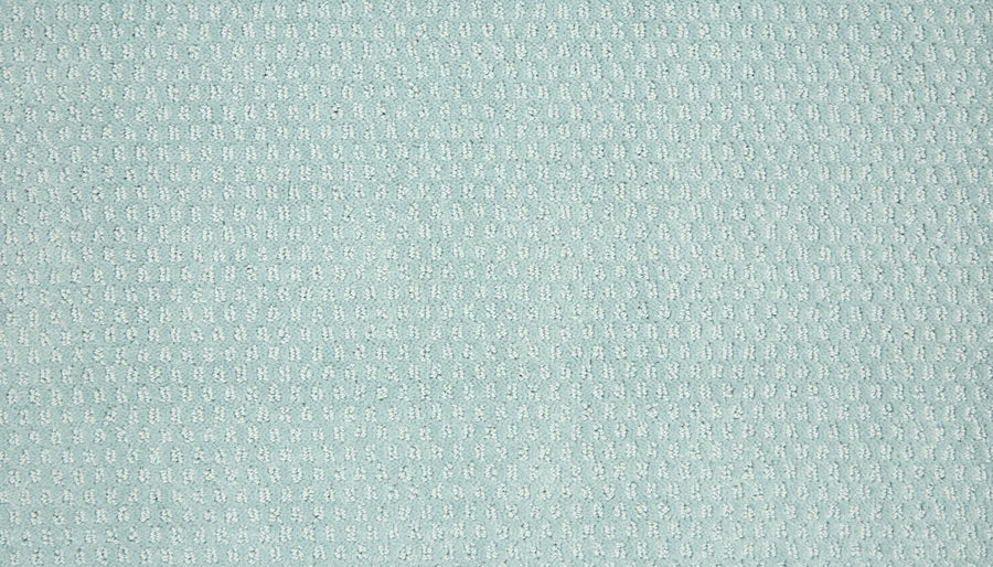 The Vintage Manner Pet Friendly Carpet features light blue textured fabric with a small repeating waffle pattern, creating a subtle raised effect and a modern, sophisticated look inspired by luxury detailing.