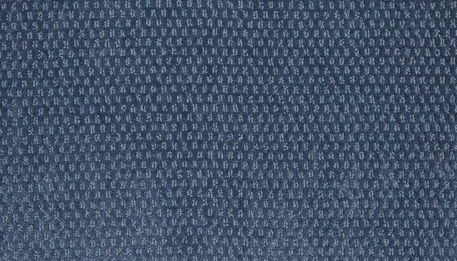 Close-up of the Vintage Manner Pet Friendly Carpet, showcasing its textured blue fabric with a repeating small grid or waffle-like pattern, resembling the soft, woven surface of a luxury carpet.