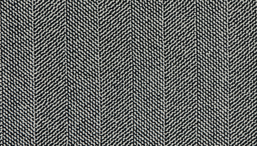 Close-up of Motley On Trend Carpet in black and white herringbone, showcasing textured zigzag lines. The woven look and alternating threads highlight its premium quality, perfect for those seeking a fashionable carpet style.