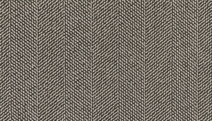 Close-up of the Motley On Trend Carpet, showcasing a premium herringbone pattern in beige and brown tones with diagonal zigzag lines for a textured, woven look.