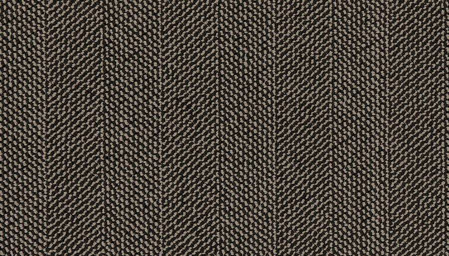 Close-up of Motley On Trend Carpet in brown herringbone, highlighting its textured weave and subtle, repeating V-shaped zigzag motif for a timeless yet modern look.