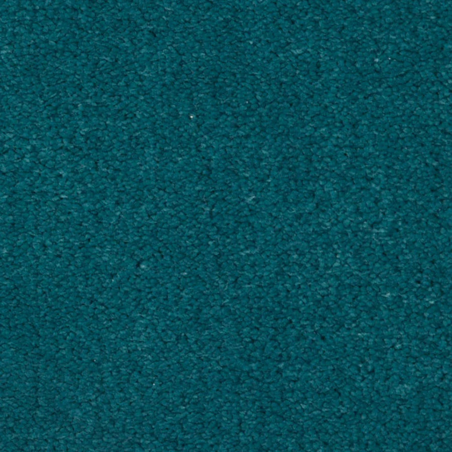 Close-up view of the Seduction On Trend Carpet in Ocean Soul, featuring a textured teal surface with a soft, slightly fuzzy appearance.