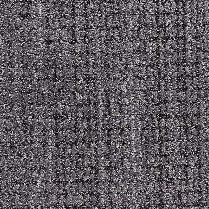 Close-up of Aspen Berber Carpet in Onyx, showing its dark gray, looped and tightly woven texture. The surface appears soft and uniform, with subtle shade variations throughout.