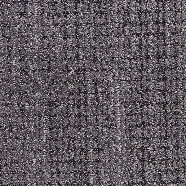 Close-up of Aspen Berber Carpet in Onyx, showing its dark gray, looped and tightly woven texture. The surface appears soft and uniform, with subtle shade variations throughout.