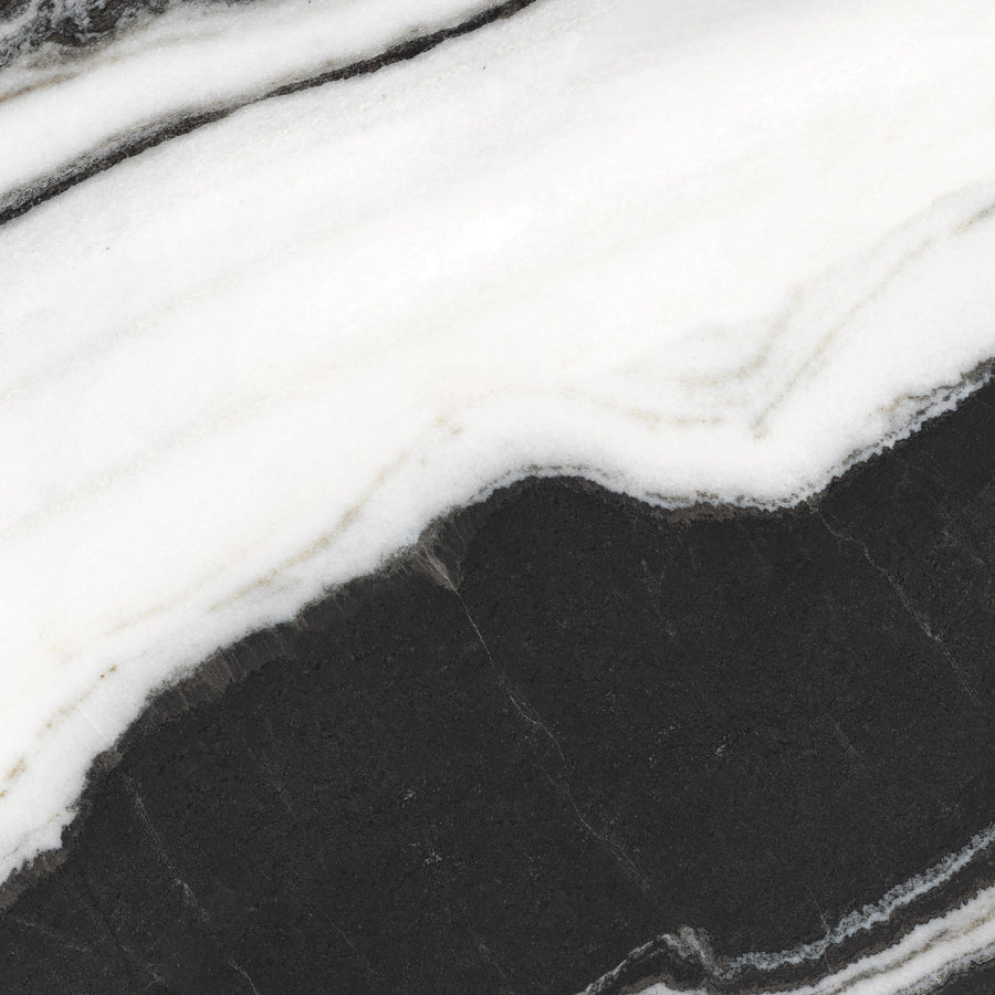 Black and white marble surface with flowing, wavy lines and natural patterns, featuring contrasting dark and light areas.