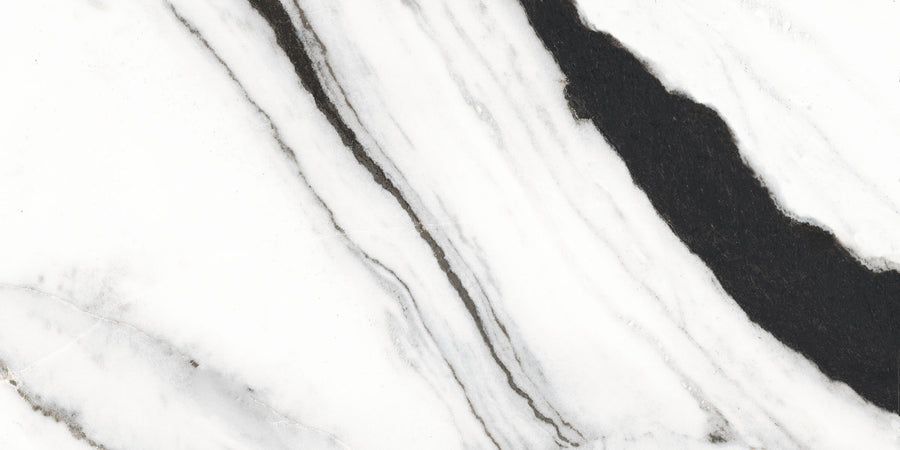 White marble surface featuring bold, irregular black and gray veins running diagonally across, creating a striking contrast and natural pattern typical of marble stone.