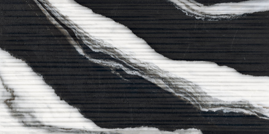 Abstract close-up of a black surface with bold, wavy white and gray marble-like streaks running diagonally, creating a natural, textured pattern.