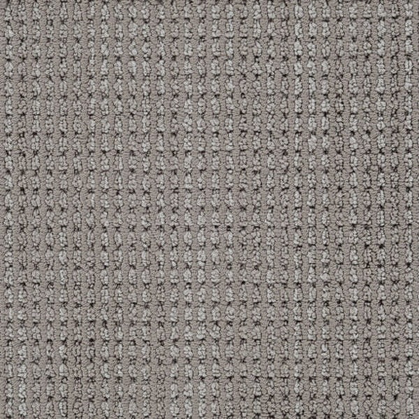 A close-up of Top Notch Berber Carpet in Otter shows its textured grid pattern with raised rectangular loops, subtle color variations, and a stylish design that’s stain resistant—an ideal choice for premium flooring.