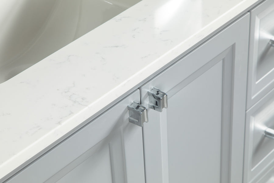 Close-up of white bathroom cabinet doors with a marble countertop, secured by a silver child safety lock near the handles.