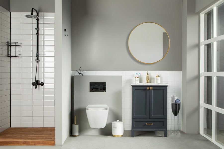 Modern bathroom with a wall-mounted toilet, dark blue vanity with a round mirror above, walk-in shower with white tiles and black fixtures, and a magazine holder by the sink.