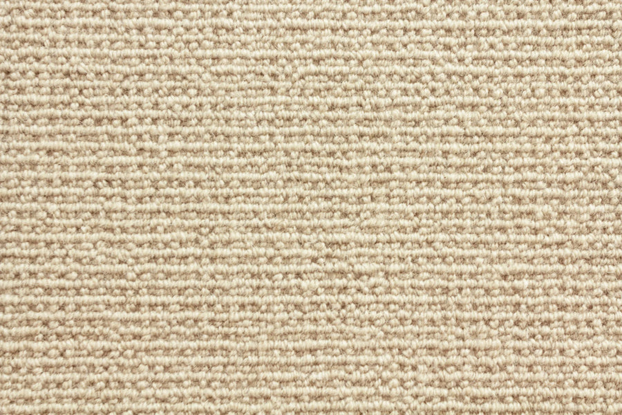 Sequoia Berber Carpet in Oyster features a tight, looped weave and subtle horizontal lines. Made from premium materials, this durable textured carpet offers a soft, uniform look ideal for high-traffic areas.