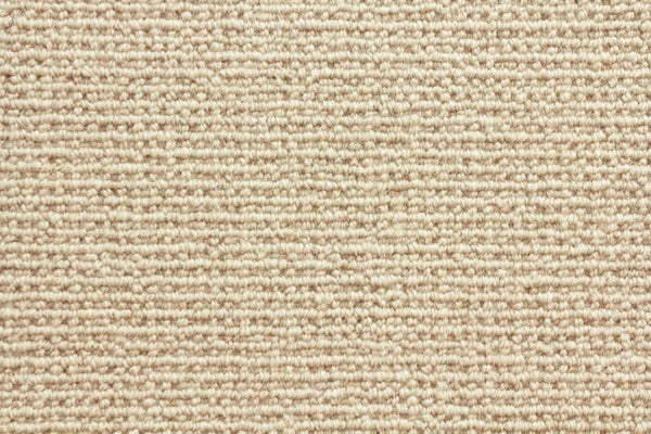 Sequoia Berber Carpet in Oyster features a tight, looped weave and subtle horizontal lines. Made from premium materials, this durable textured carpet offers a soft, uniform look ideal for high-traffic areas.