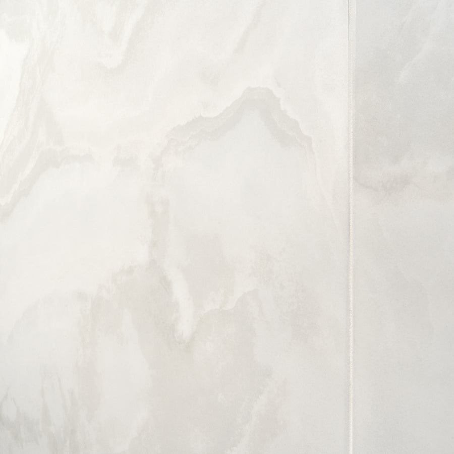 A close-up of the Aura 48" x 48" Porcelain Tile in White, showcasing subtle wavy patterns, natural veining, and a vertical seam that highlights its oversized format—perfect for modern interiors.