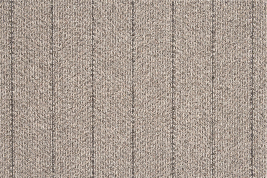 The Pacific Stripe On Trend Carpet in Ash is a modern, light brown textured carpet with a subtle herringbone pattern and thin, evenly spaced vertical dark lines for an elegant striped look.