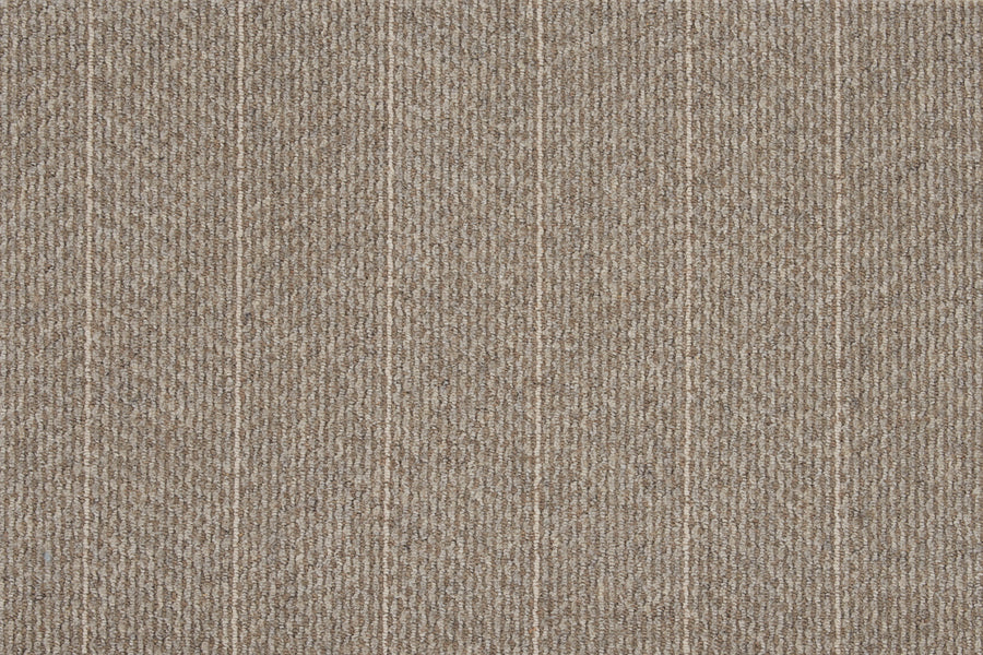 Close-up of Pacific Stripe On Trend Carpet in Heath color, featuring a textured beige surface with subtle vertical lines and small dotted details for a modern, neutral look.