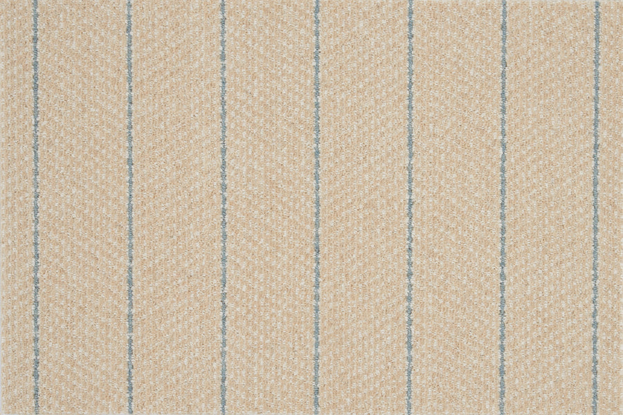 Close-up of the Pacific Stripe On Trend Carpet in Maize, showing beige textured fabric with diagonal lines and evenly spaced vertical blue stripes for a subtle herringbone effect and modern style.