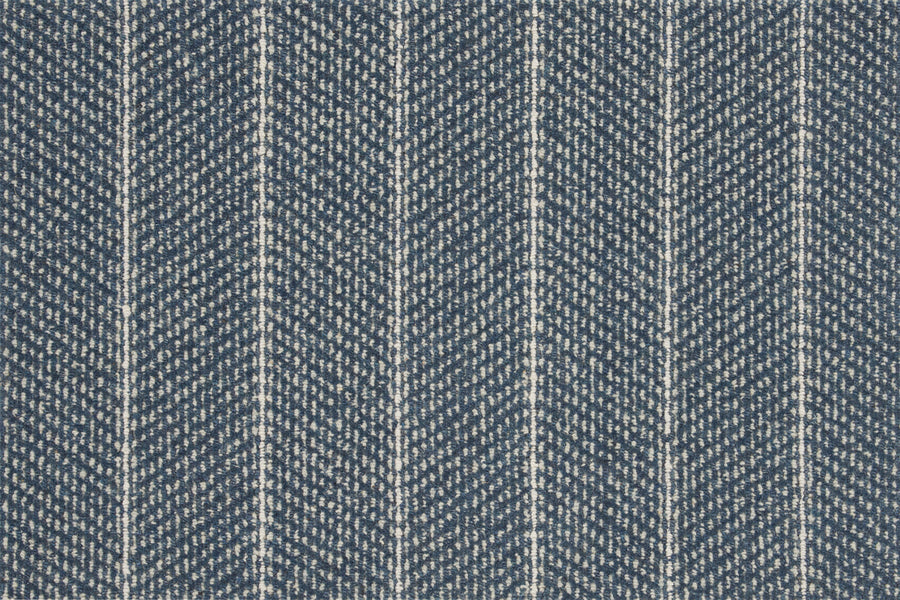 Close-up of blue denim fabric with a white herringbone pattern, echoing the zigzag and vertical stripe design of the Pacific Stripe On Trend Carpet in Marina color.