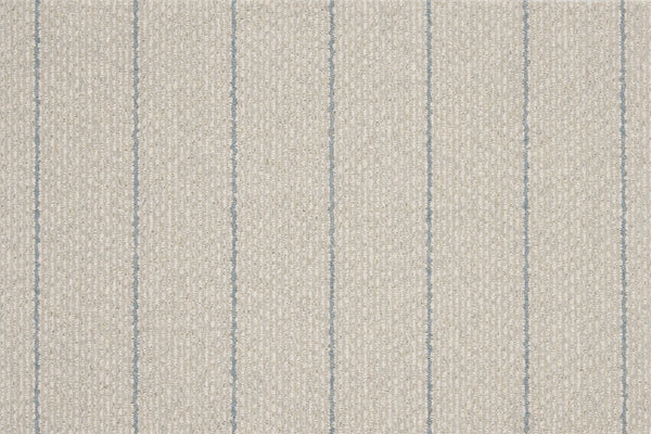 Featuring a textured beige surface with evenly spaced thin vertical blue lines, Pacific Stripe On Trend Carpet in Mist delivers a simple yet contemporary striped pattern.