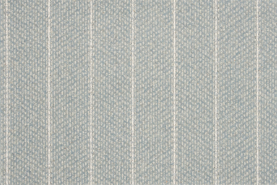 The Pacific Stripe On Trend Carpet in Surf features a light blue textured fabric with a subtle herringbone pattern and evenly spaced vertical white stripes, offering a contemporary look and a soft, woven surface.