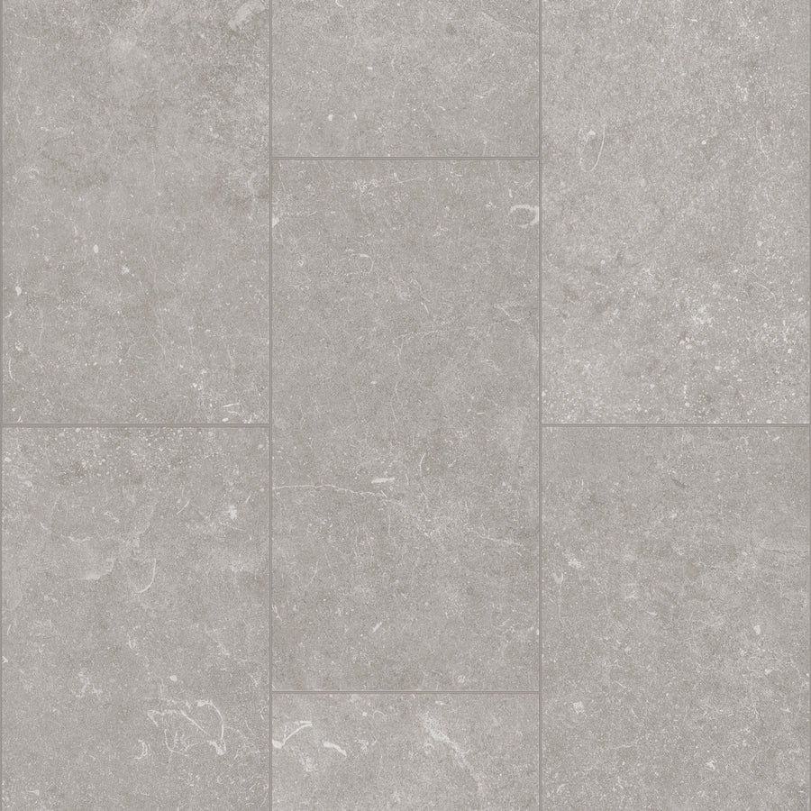 Paragon Tile Plus Vinyl features gray rectangular tiles with a subtle mottled texture and faint white veining in an offset layout. The matte, evenly colored surface is ideal for both flooring and wall applications.