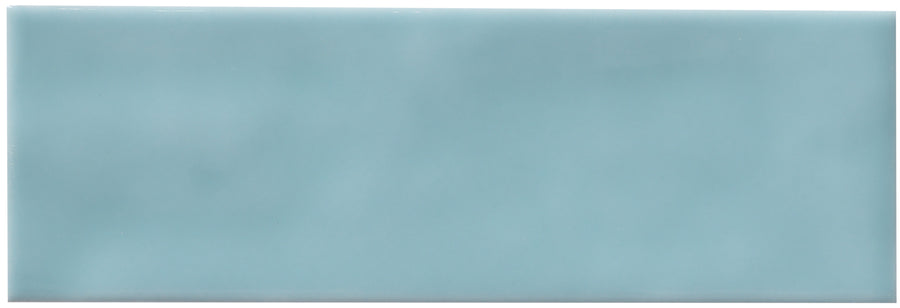 The Zephyr 2x6 Ceramic Tile is a rectangular, glossy, light blue tile with smooth edges and uniform color, inspired by Mediterranean design for a handcrafted luxury look.