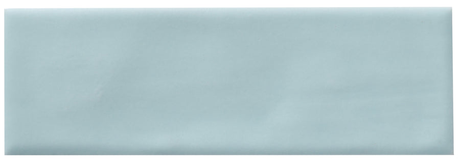 The Zephyr 2x6 Ceramic Tile features a rectangular, light blue design with a smooth glossy finish and subtle shading, offering handcrafted luxury and Mediterranean charm.