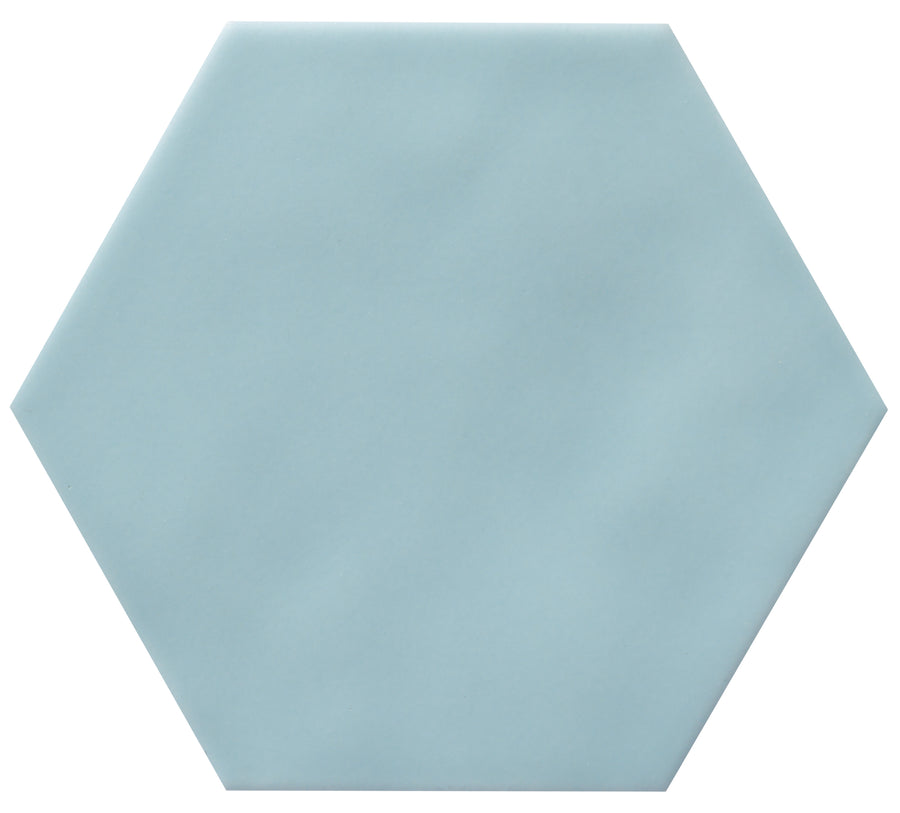 The Zephyr 4.2x4.9 Hexagon Ceramic Tile is a light blue, flat, hexagonal ceramic tile with smooth edges, Mediterranean-inspired design, displayed on a white background. Special-order item.