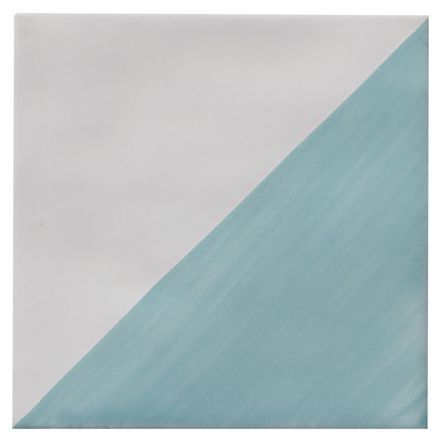 The Zephyr 4x4 Compass Deco Ceramic Tile features a diagonal split: the upper left is white, while the lower right displays a light blue gradient inspired by artisanal Mediterranean tile design.