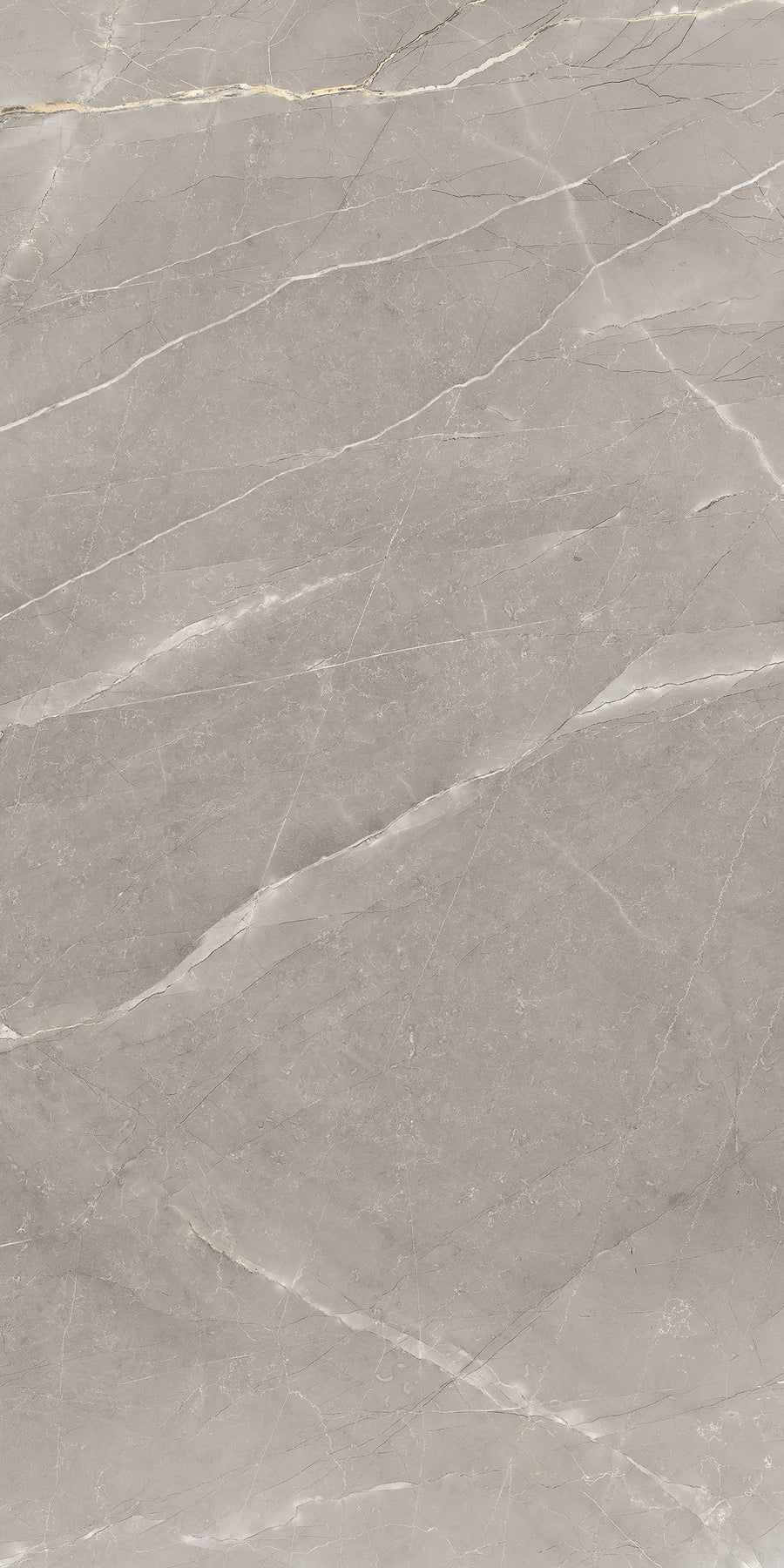 A close-up view of a smooth, beige marble surface with subtle white and gray veins running diagonally across it. The texture appears polished and slightly reflective.