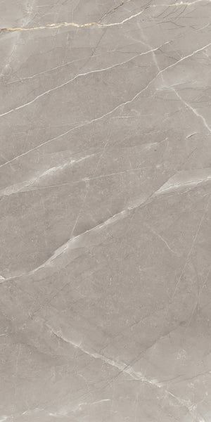 A close-up view of a smooth, beige marble surface with subtle white and gray veins running diagonally across it. The texture appears polished and slightly reflective.